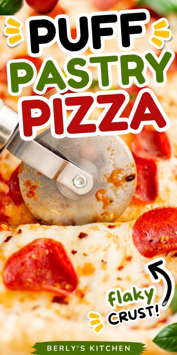 Pizza cutter cutting a puff pastry pizza.