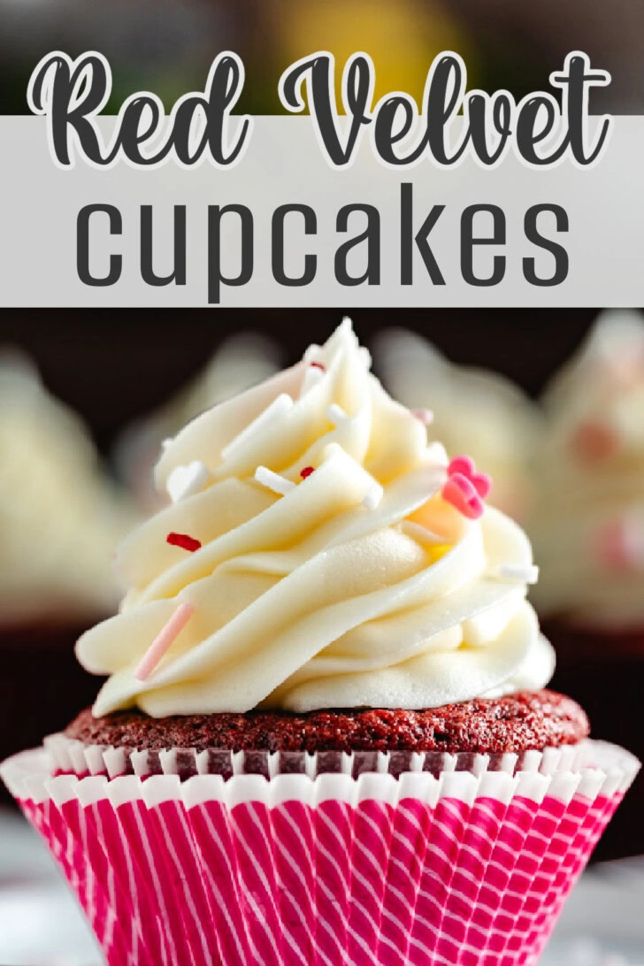 Side view of a red velvet cupcake with cream cheese frosting and sprinkles.