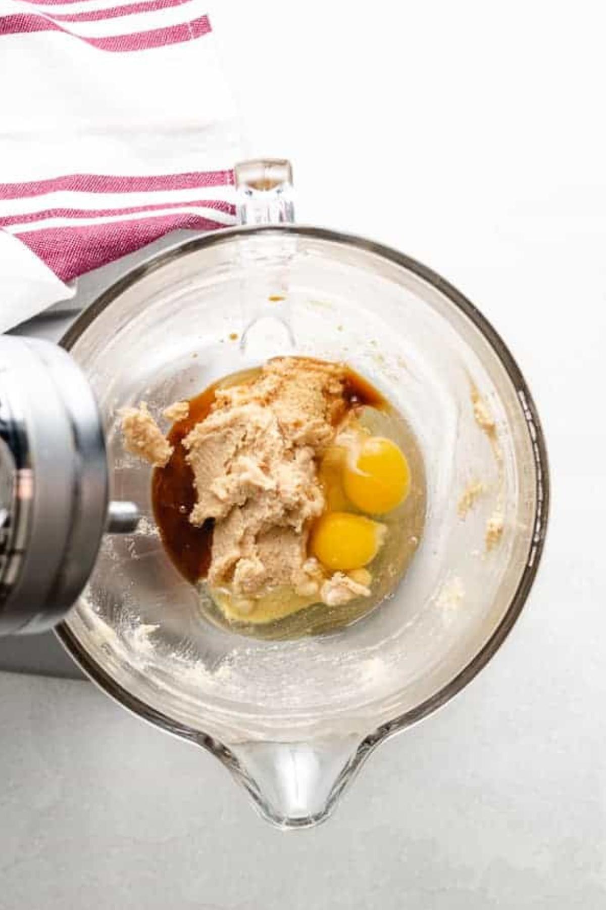Eggs and vanilla added to creamed butter and sugar mixture.