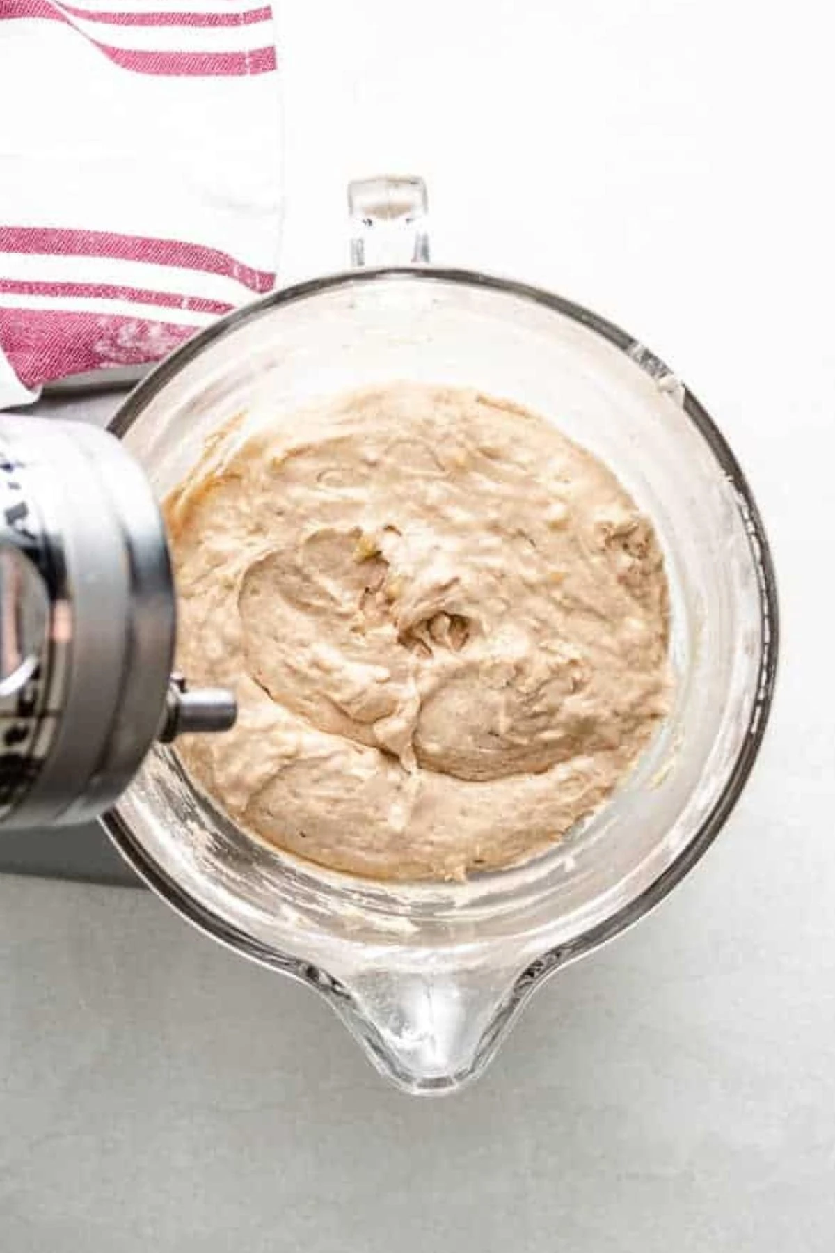 Sourdough banana bread batter in a glass mixing bowl.