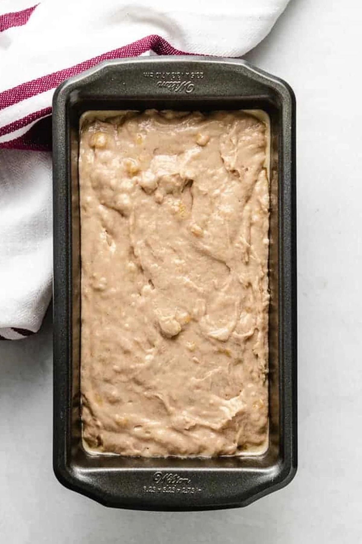 Banana bread batter in a loaf pan.