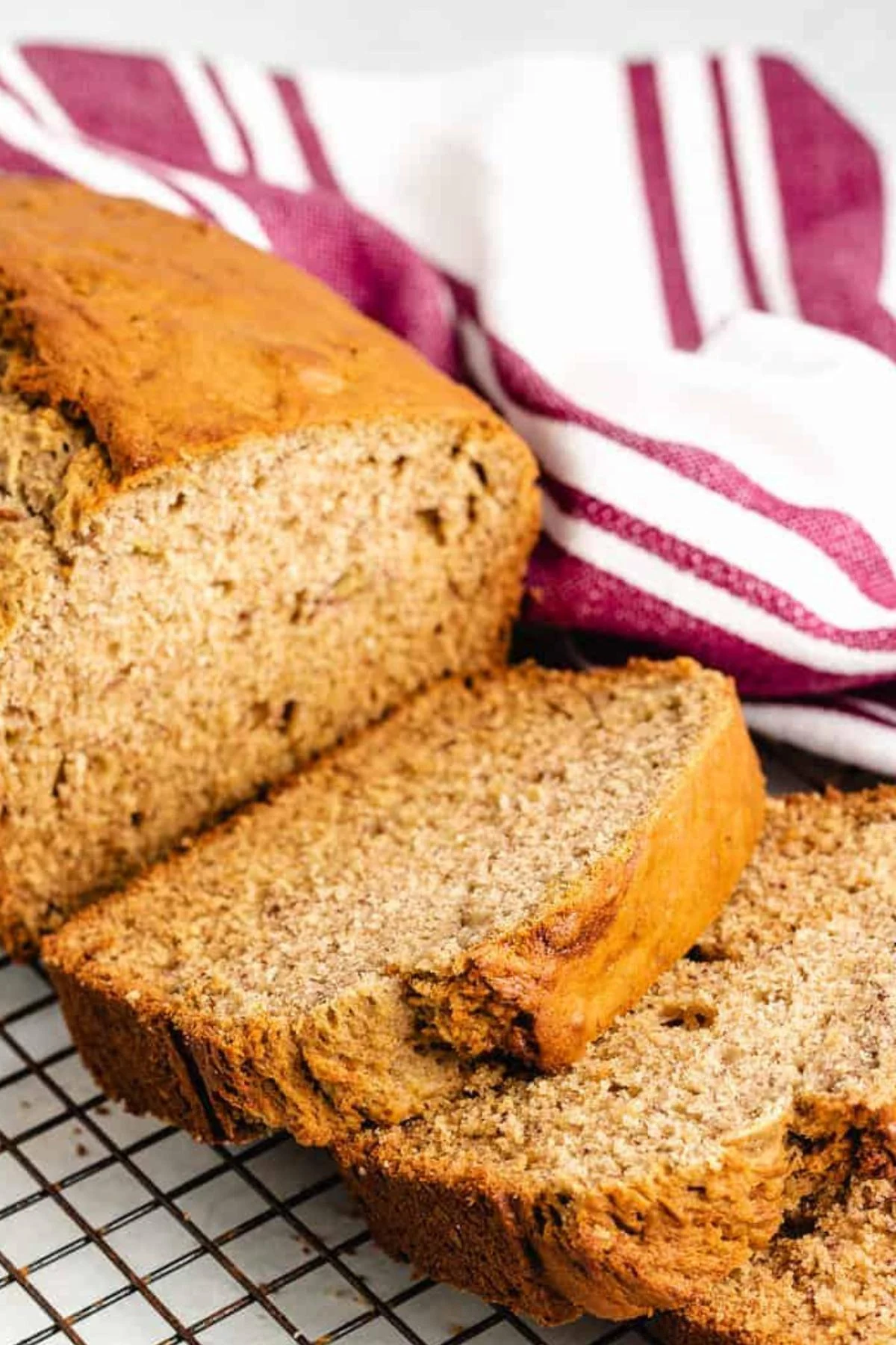 Sourdough banana bread sliced on a wire rack.