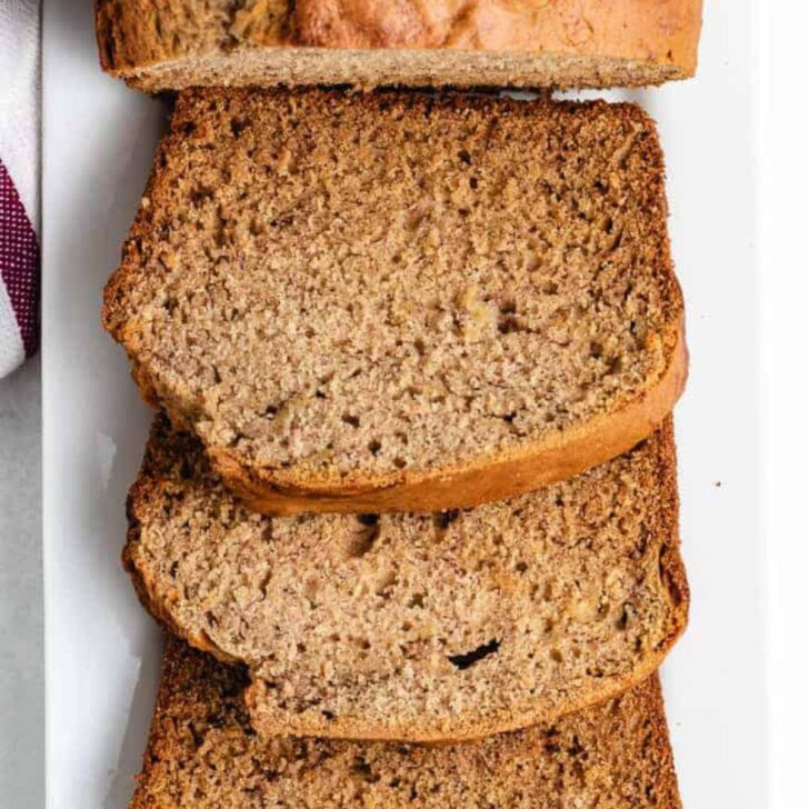 Overhead view of sourdough banana bread slices arranged on a platter.