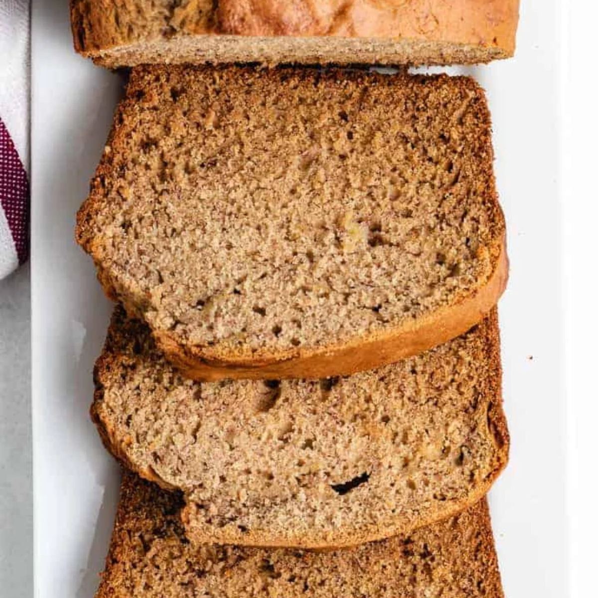 Overhead view of sourdough banana bread slices arranged on a platter.