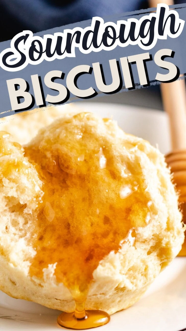 Close up view of a sourdough biscuit drizzled with honey.