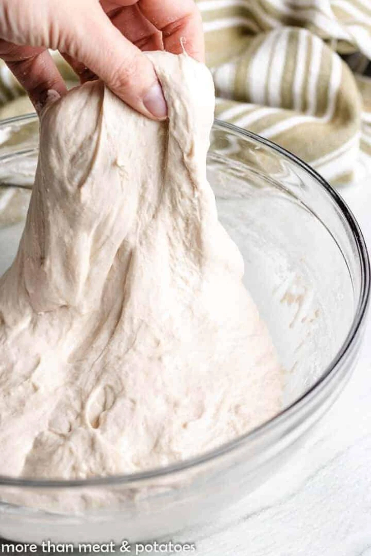 Stretch and folds being completed on bread dough.