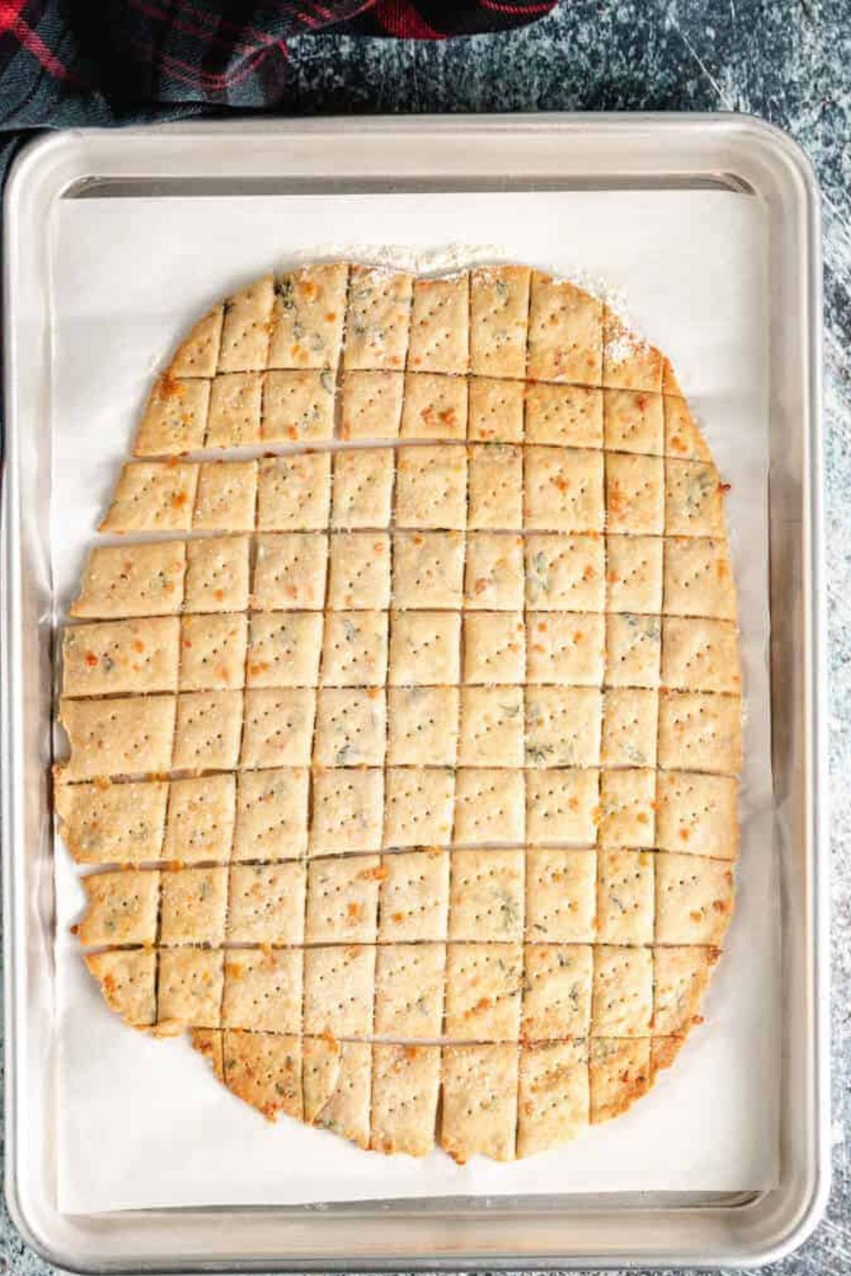 Baked parmesan crackers on a baking sheet.