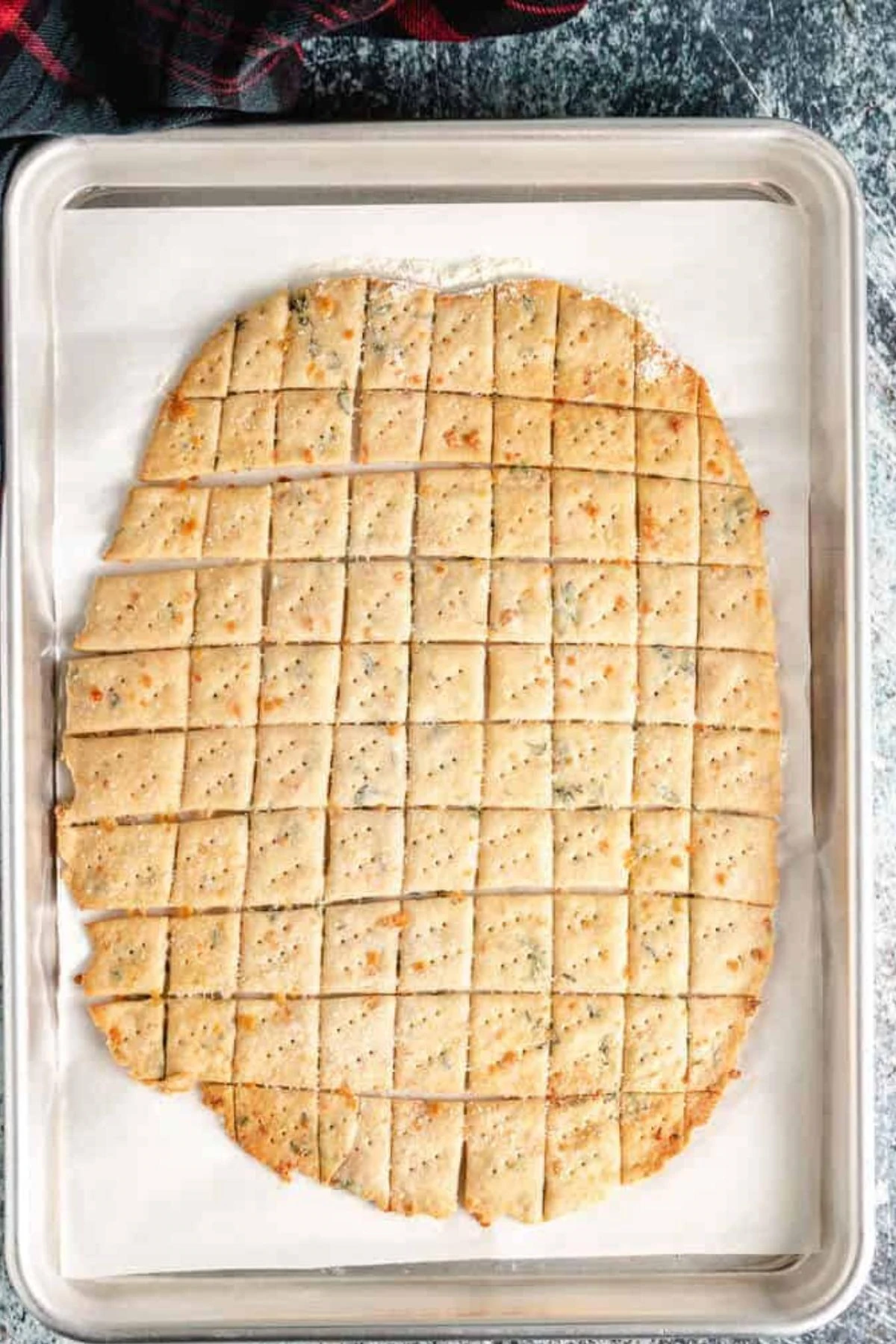 Baked parmesan crackers on a baking sheet.