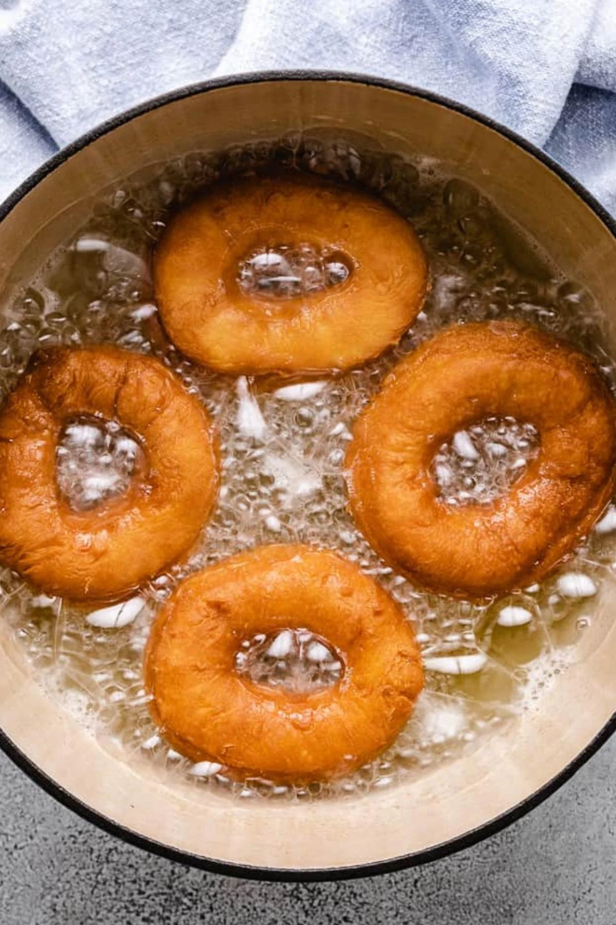 Doughnuts frying in oil.