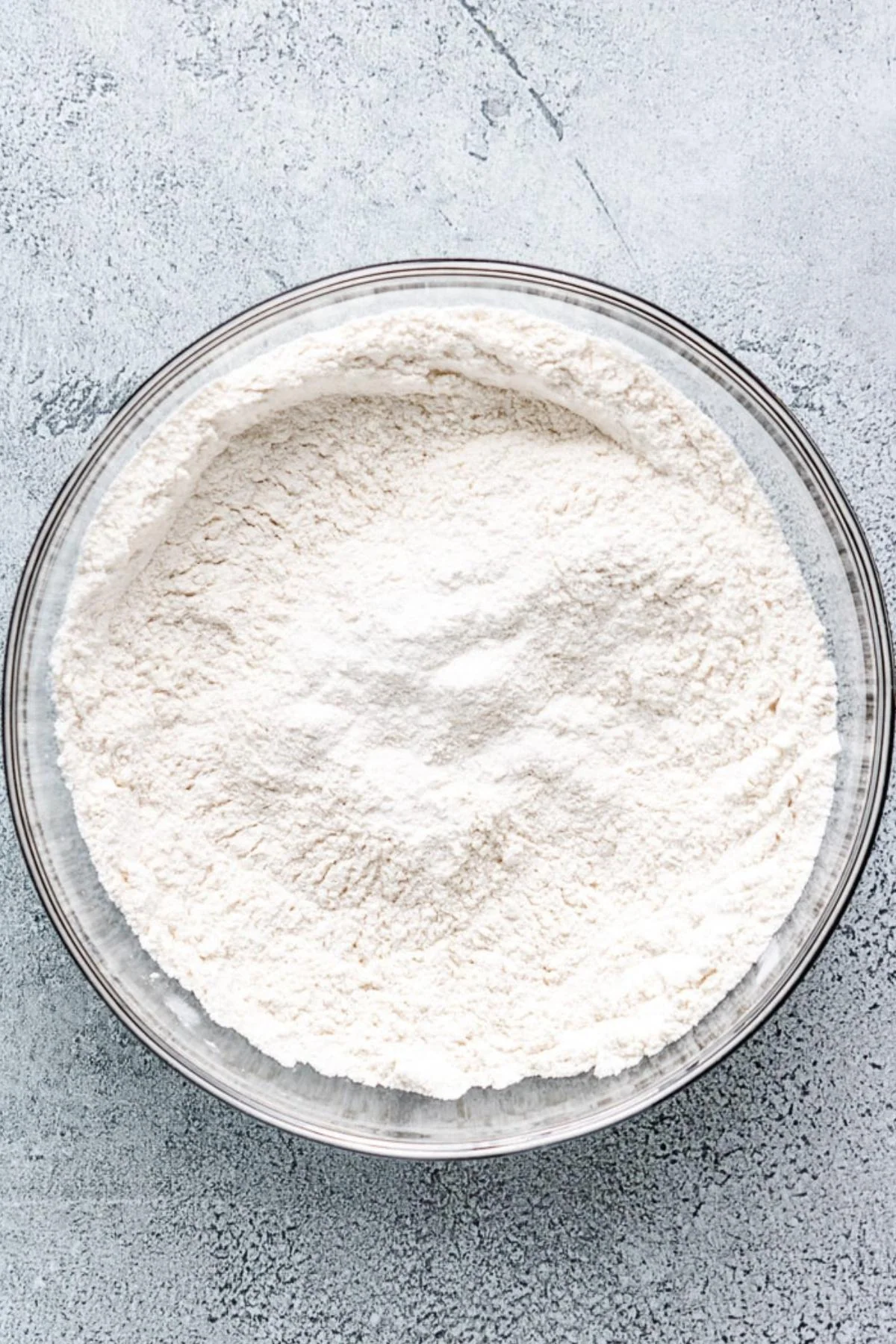 Flour, baking powder, baking soda, and salt combined in a bowl.