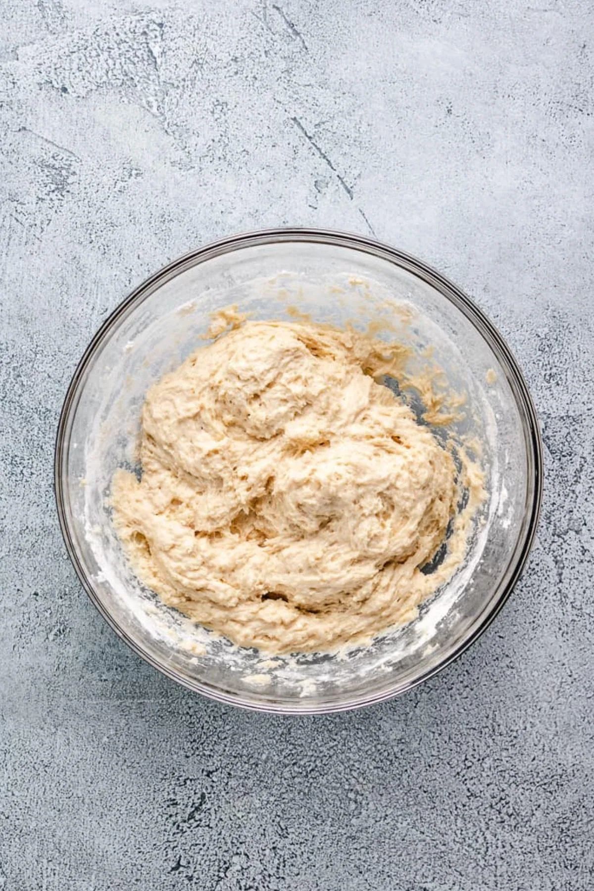 Sourdough doughnut dough in a glass bowl.