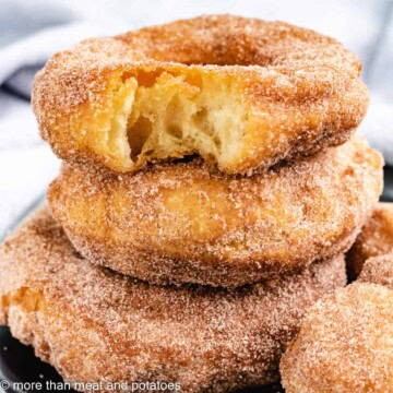 Stack of sourdough doughnuts next to doughnut holes.