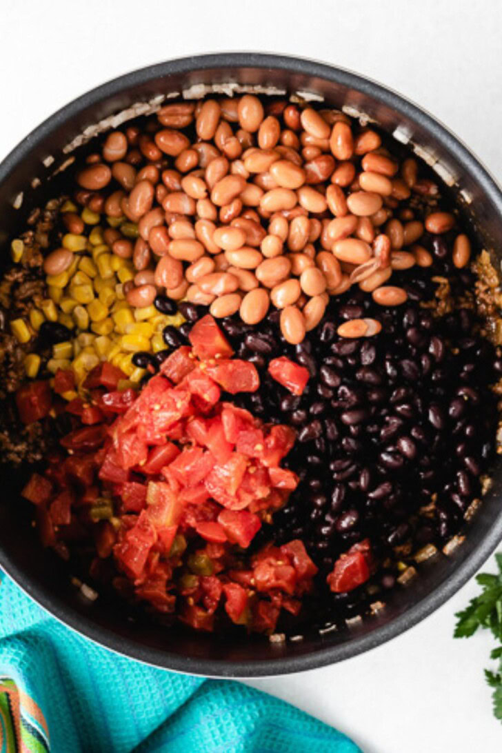 Beans, corn, and tomatoes added to seasoned ground beef.