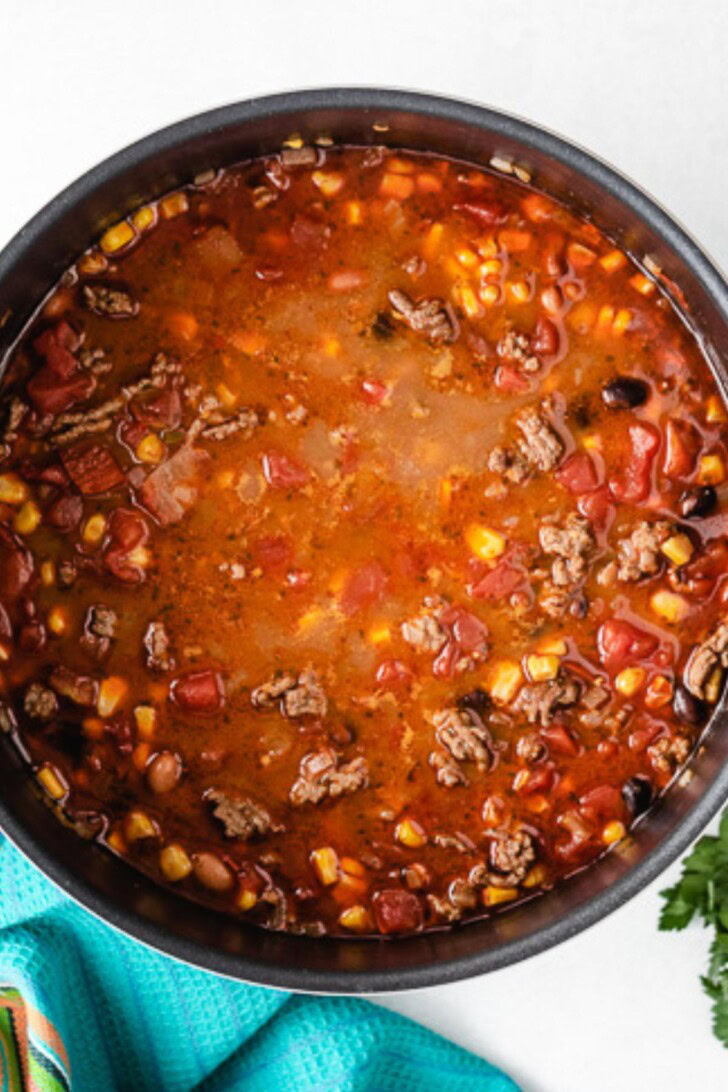 Broth added to a pan of taco soup.