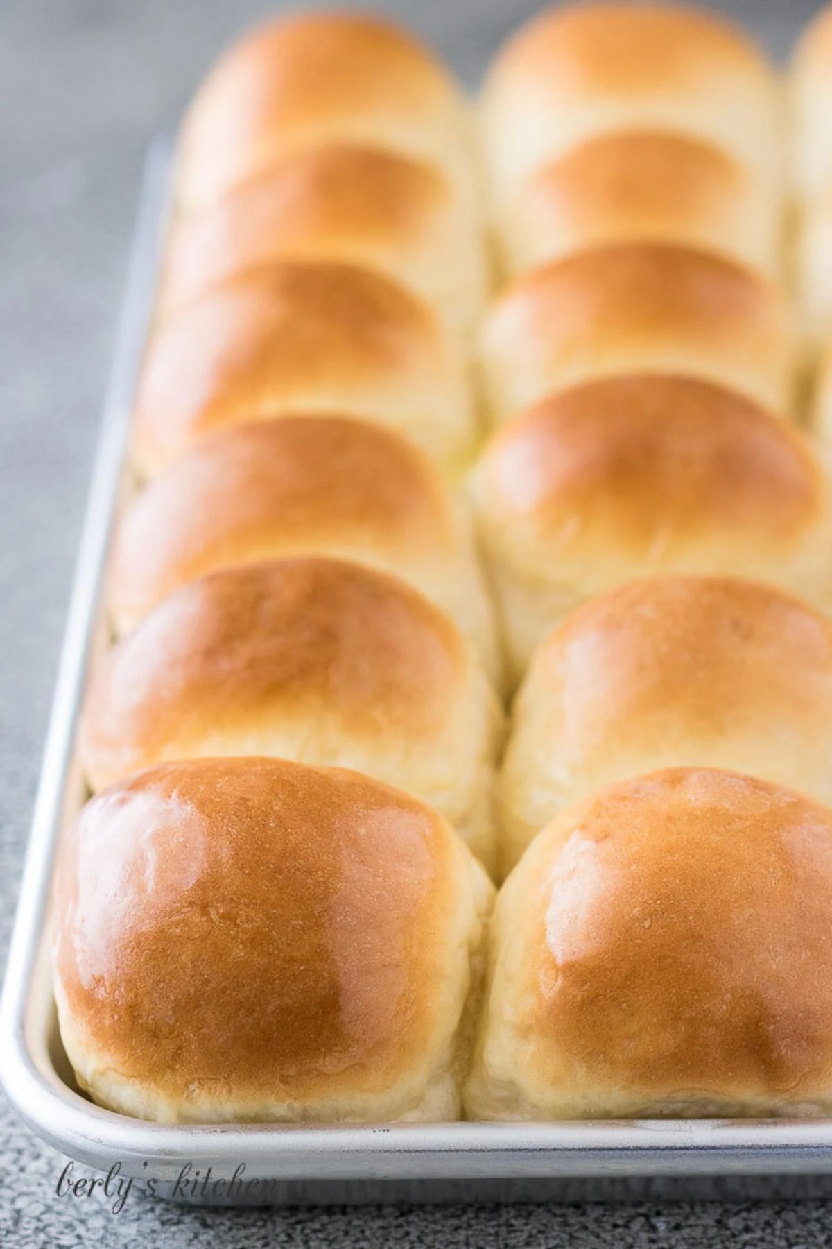 Homemade yeast rolls on a baking sheet.