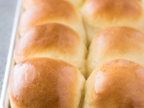 Golden brown yeast rolls on a plate.