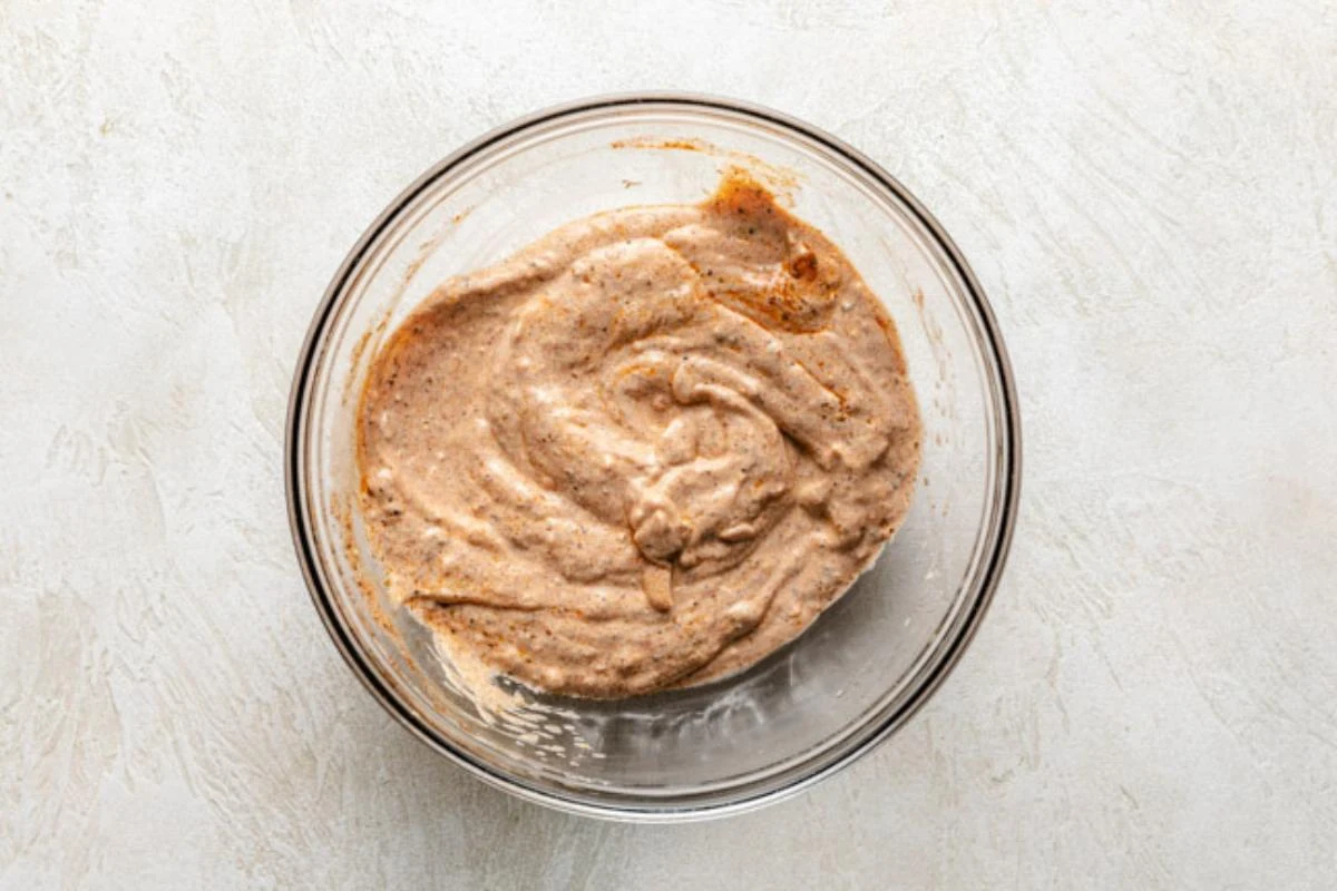 Yogurt chicken marinade in a glass bowl.