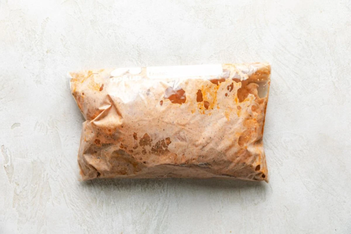 Chicken breasts marinating in a ziploc bag.