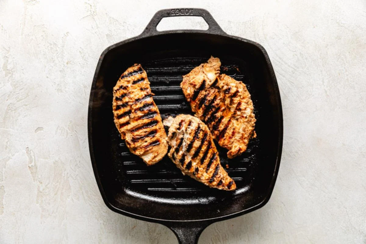 Chicken cooking in a pan.