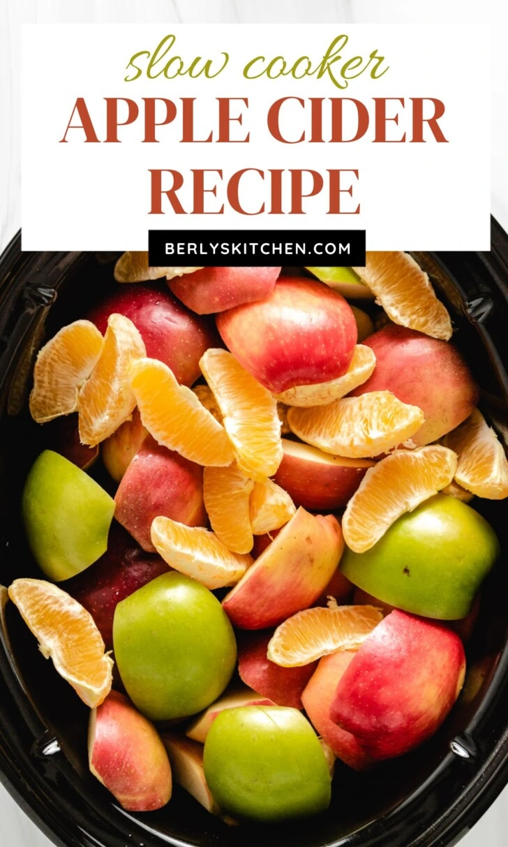 Close up view of apples and oranges in a slow cooker.