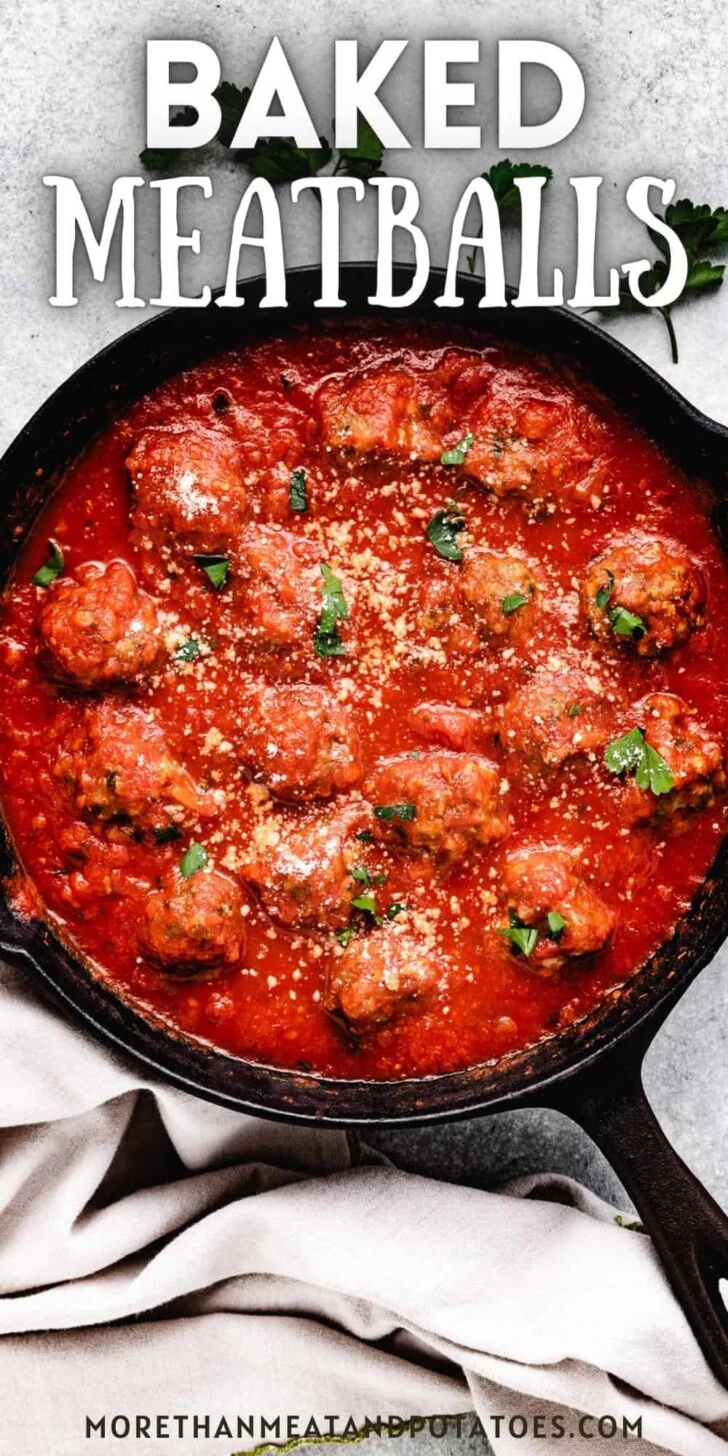 Close up view of a pan of baked meatballs in marinara.