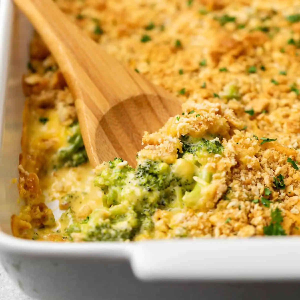 Close up view of broccoli casserole in a baking dish.