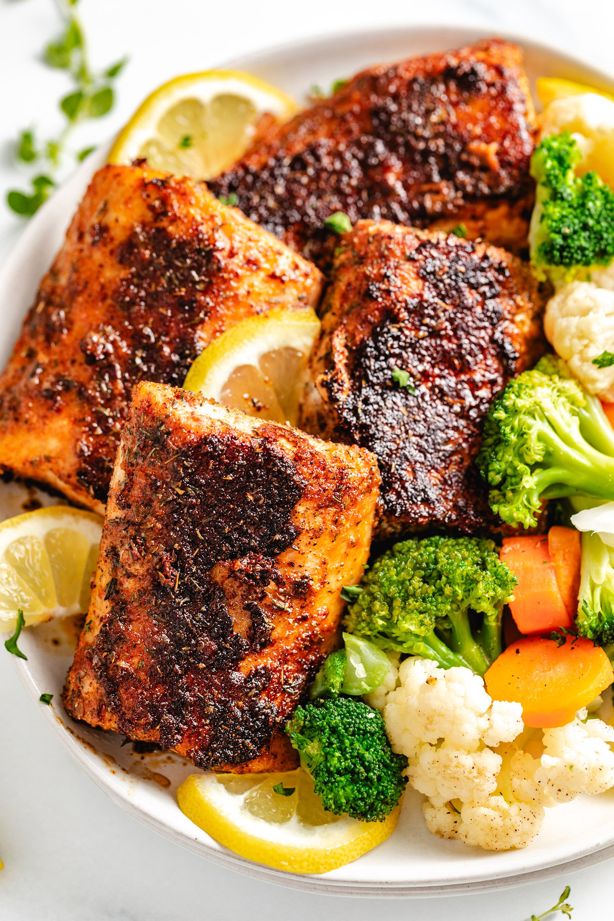 Blackened mahi mahi with lemon and vegetables.