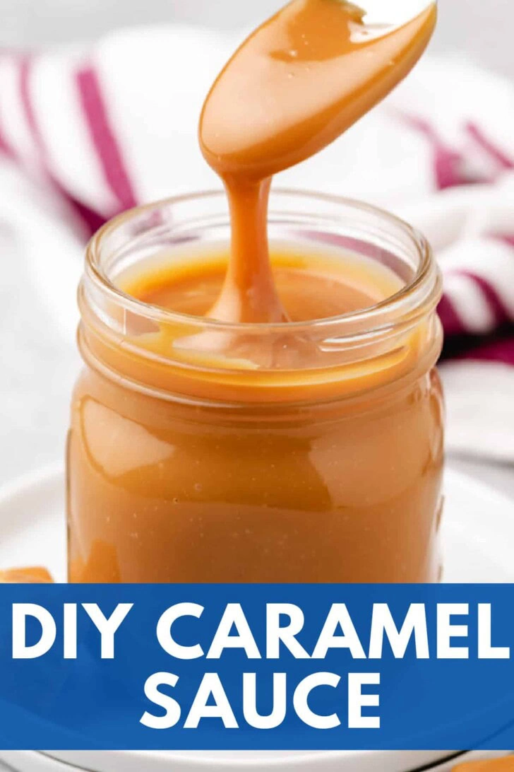 Spoon holding up caramel sauce from a jar.