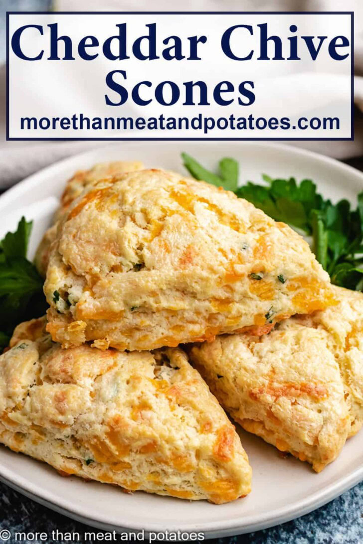 Pile of cheddar chive scones on a plate.