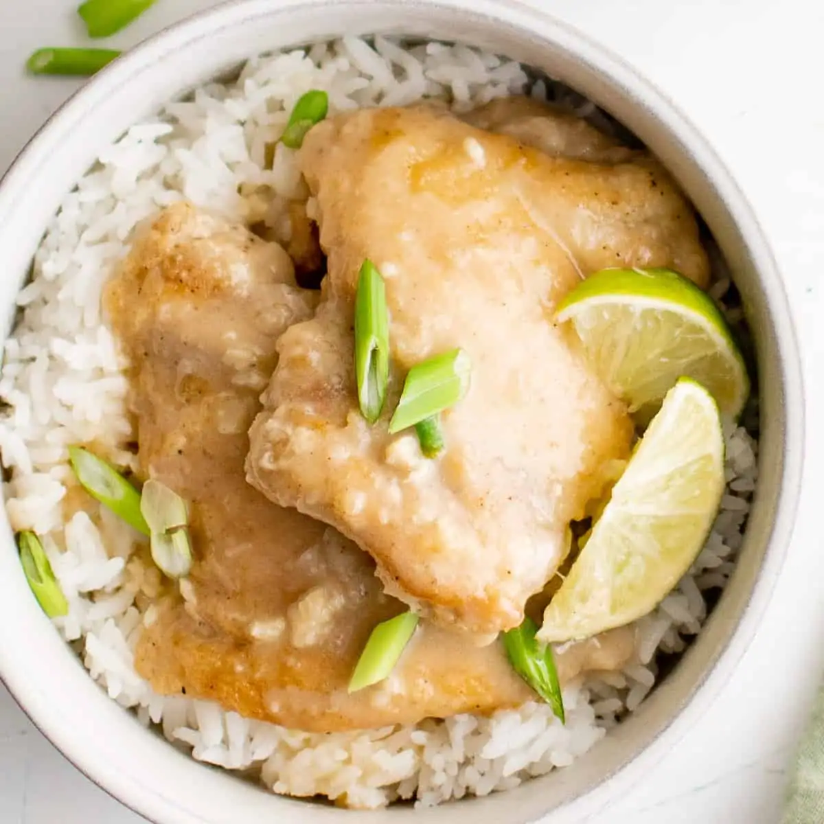 Overhead view of coconut lime chicken in a bowl with rice.