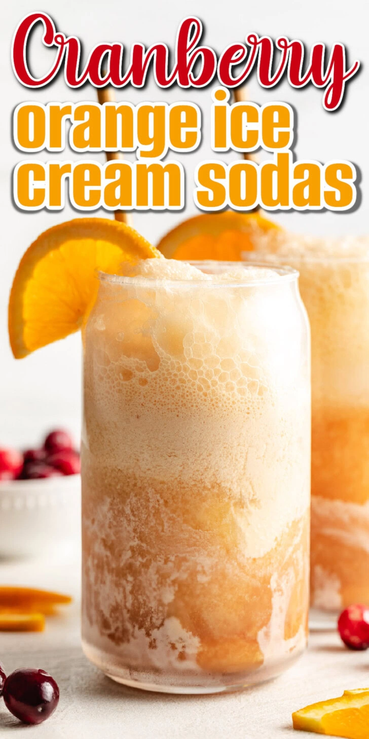 Cranberry orange ice cream soda with an orange slice.