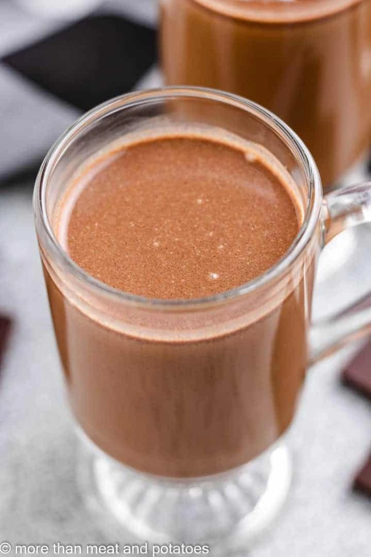 Dark chocolate coffee poured into a glass mug.