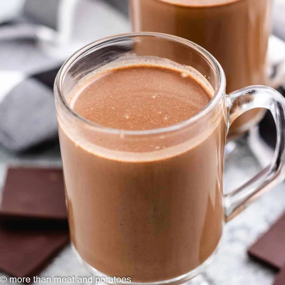 Glass mugs filled with dark chocolate coffee.