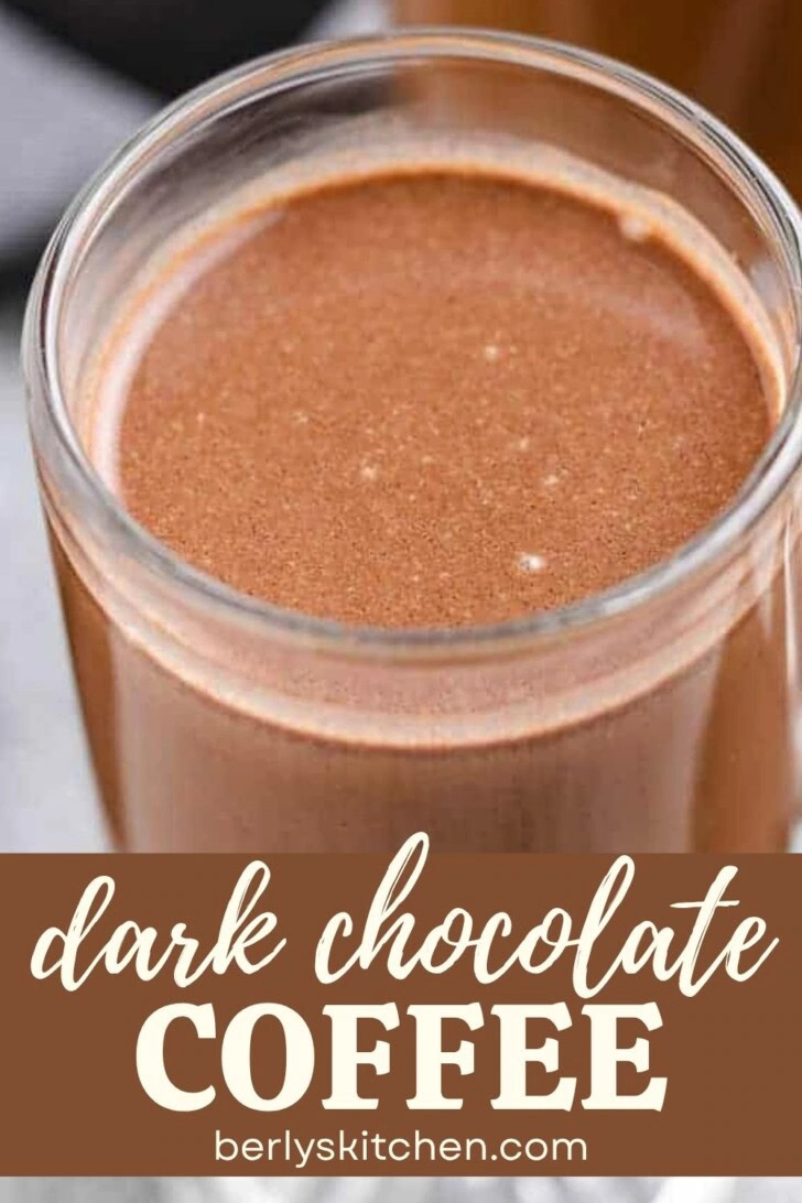 Close up view of a mug of dark chocolate coffee.