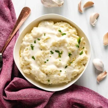 Overhead view of a bowl of garlic mashed potatoes.