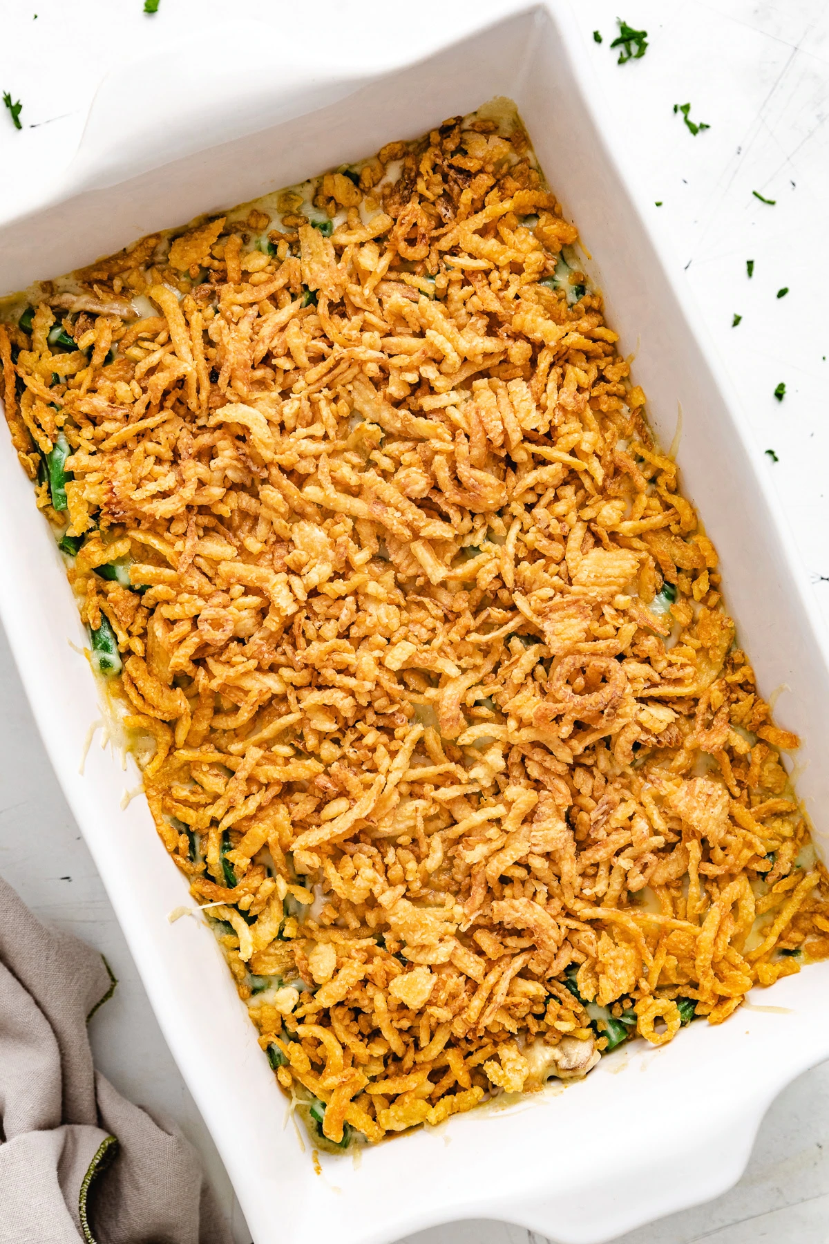 Baked green bean casserole with a golden onion topping.