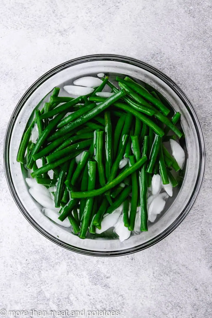 Green beans in an ice bath.