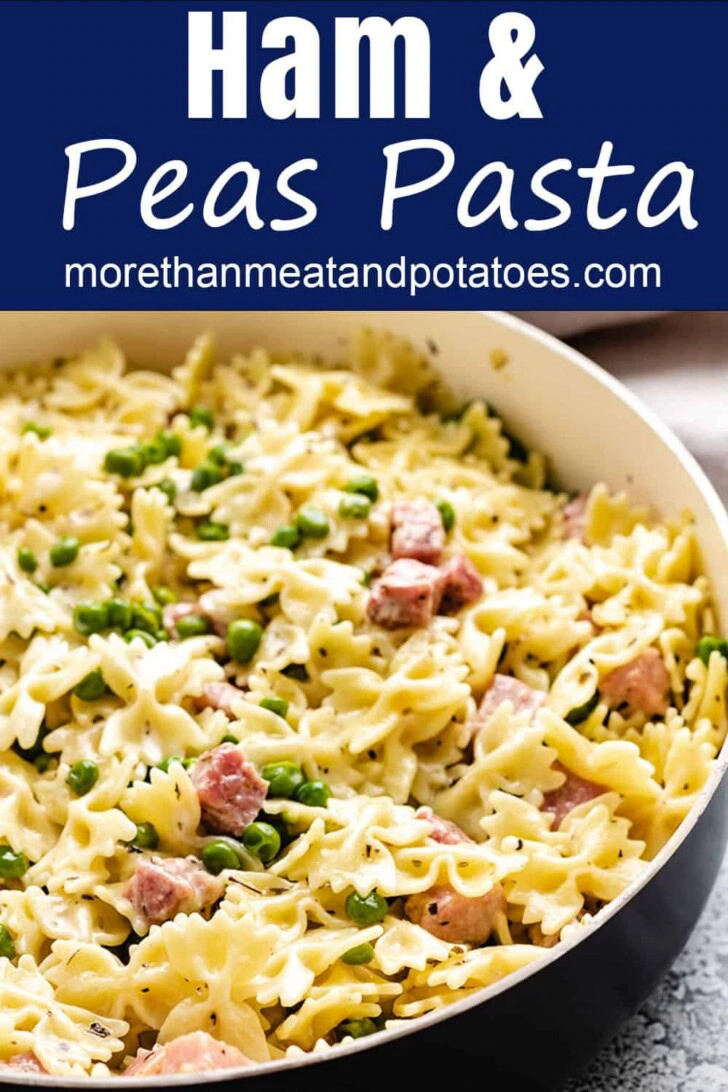 Close up view of a skillet filled with ham and peas pasta.