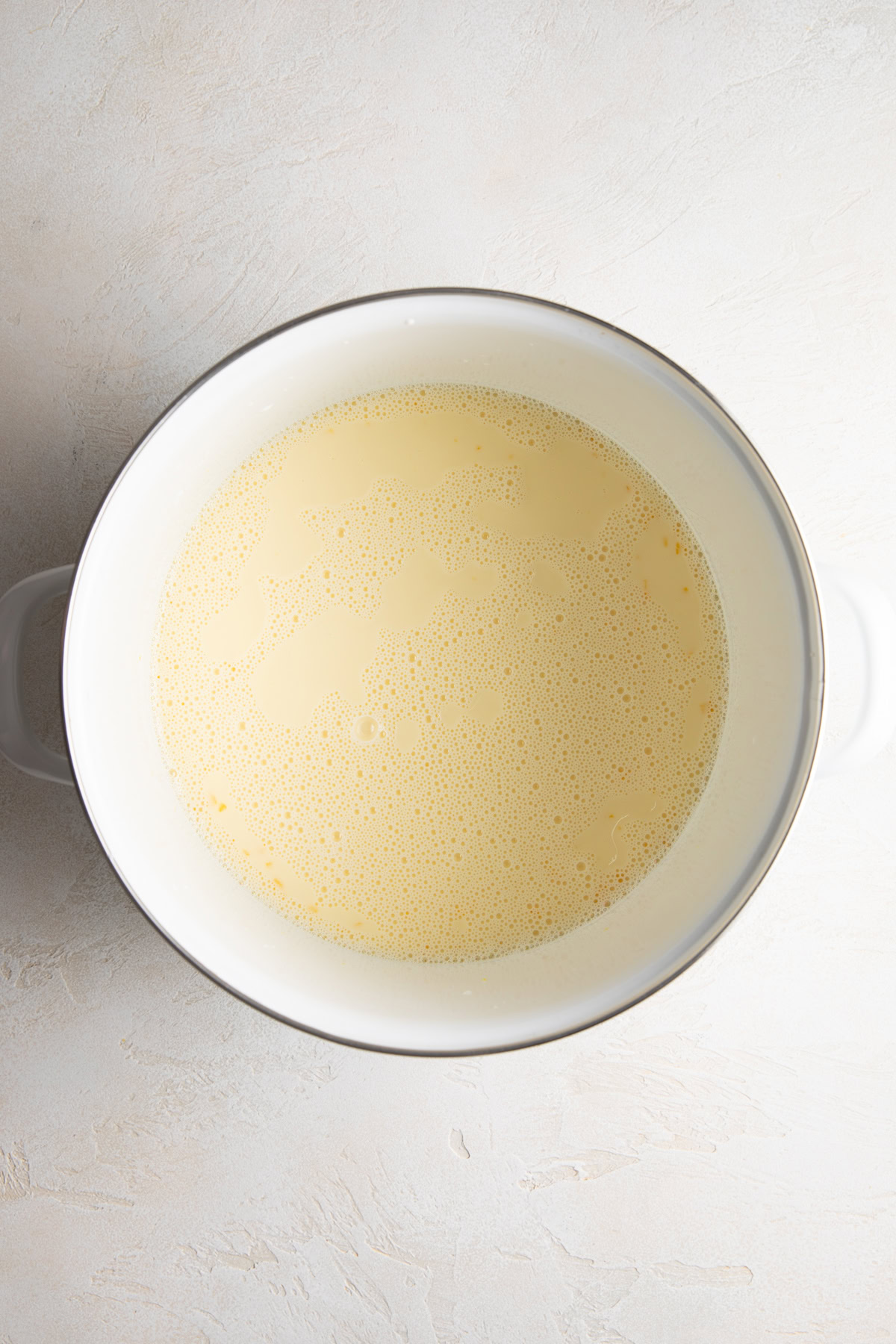 Vanilla ice cream base in a saucepan.