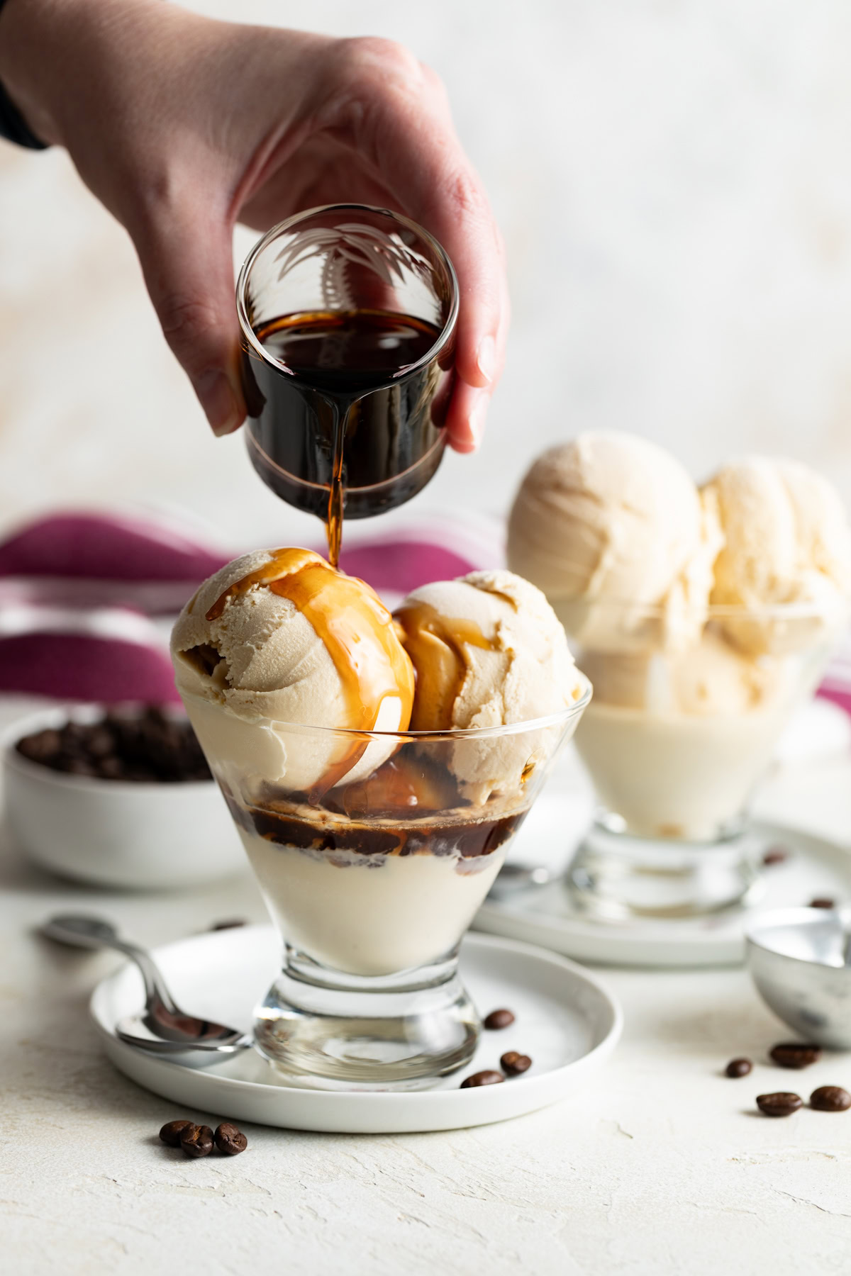 Kahlua coffee liqueur being poured over Kahlua ice cream.