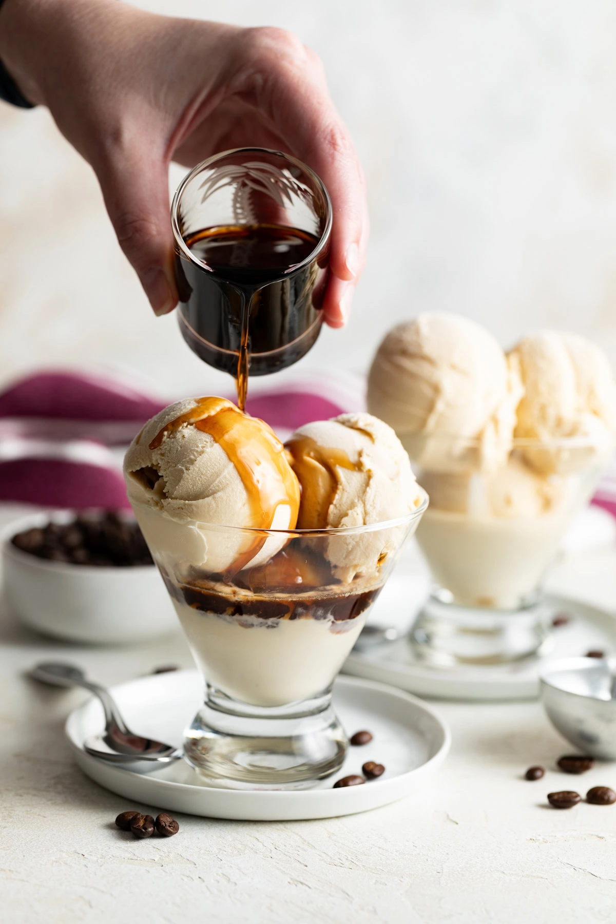 Kahlua coffee liqueur being poured over Kahlua ice cream.
