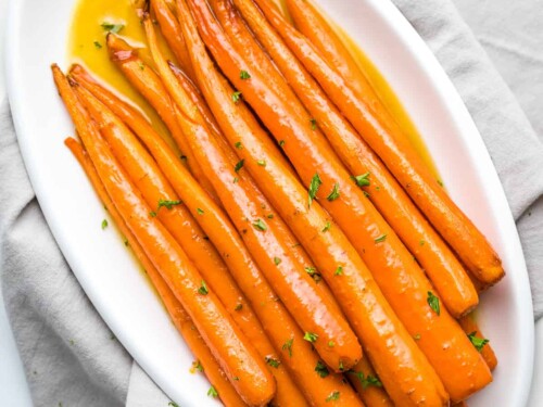 Overhead view of maple roasted carrots on a platter.