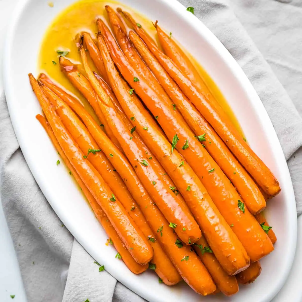 Overhead view of maple roasted carrots on a platter.