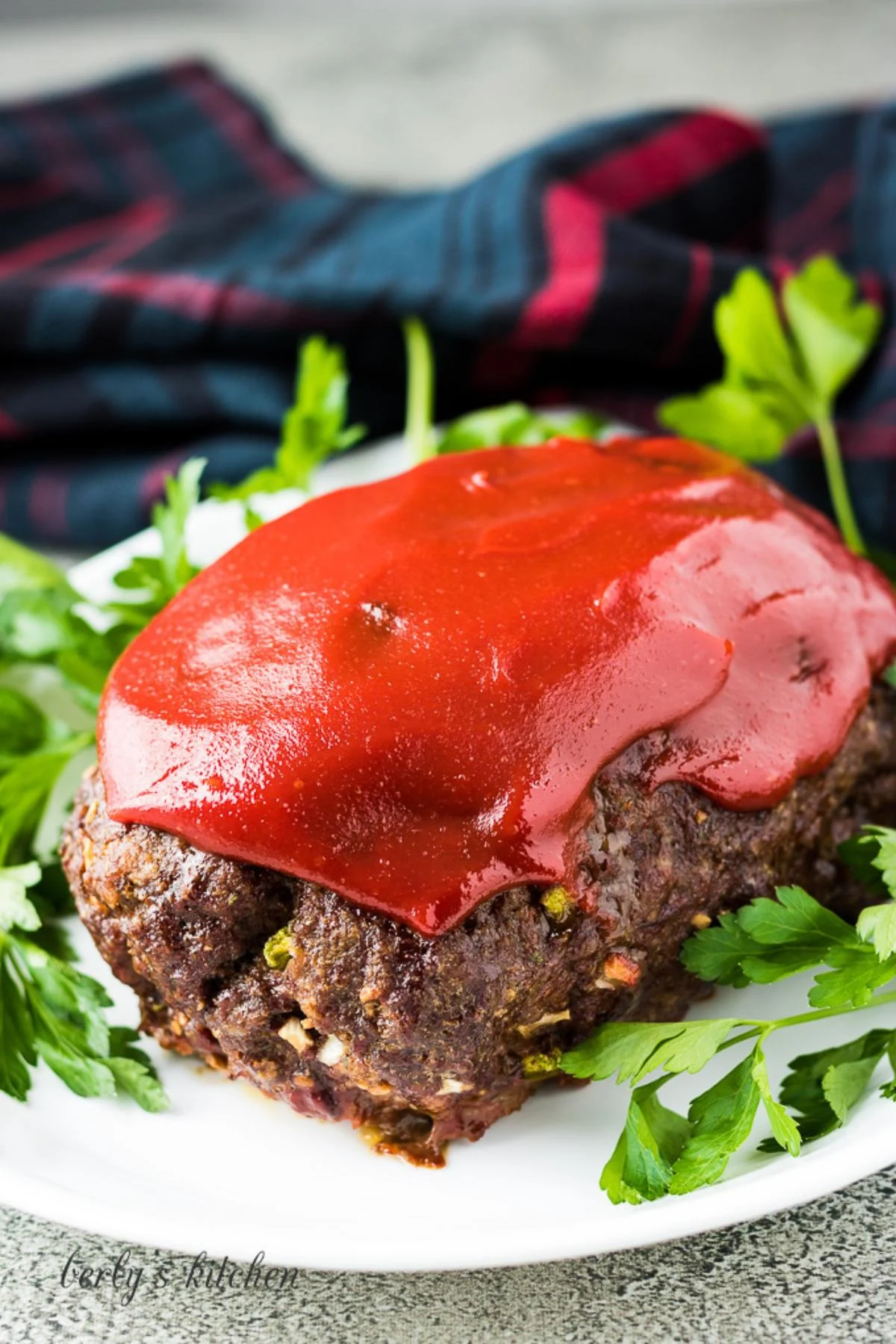 Full meatloaf on a white plate.