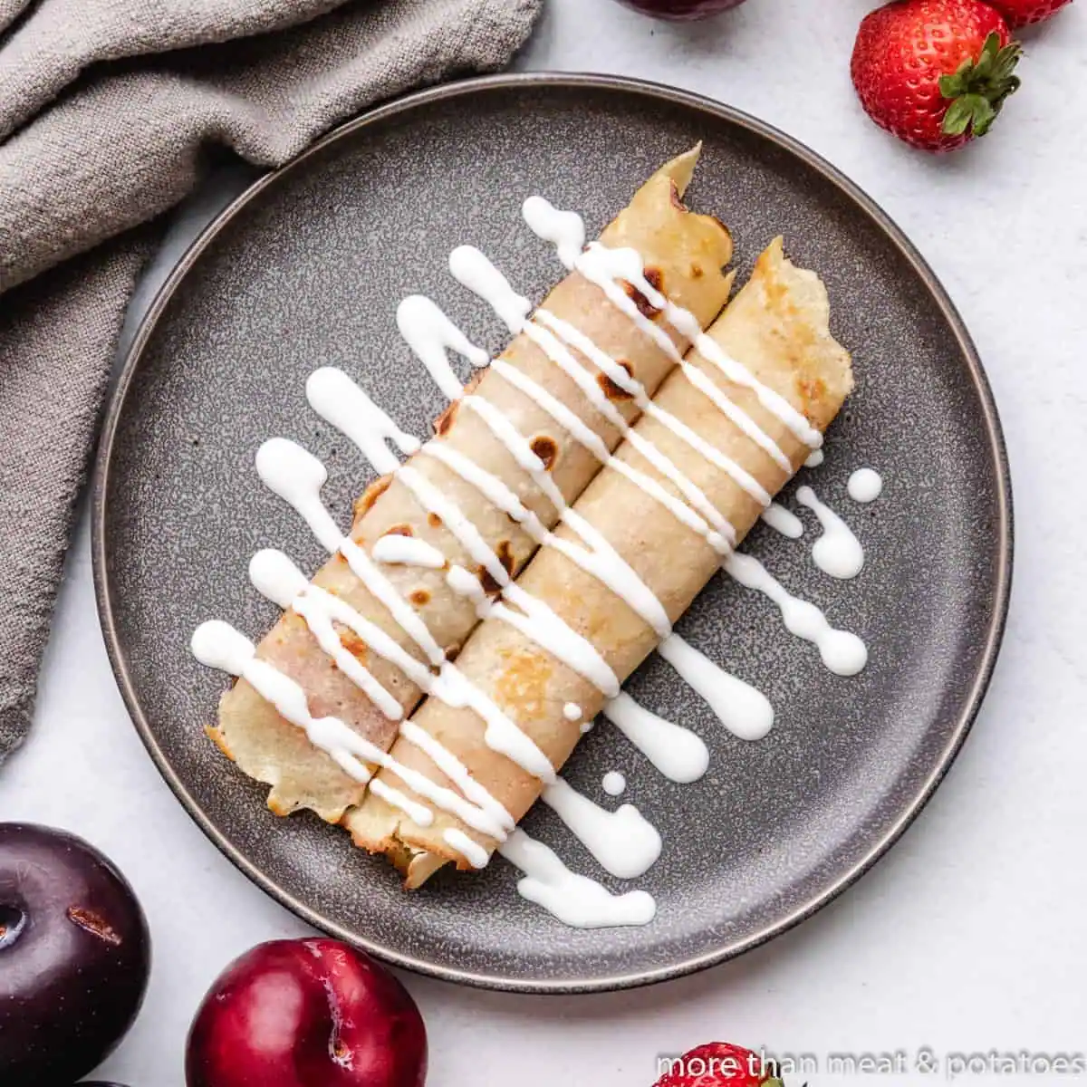 Overhead view of Hungarian pancakes (palacsintas) on a plate.