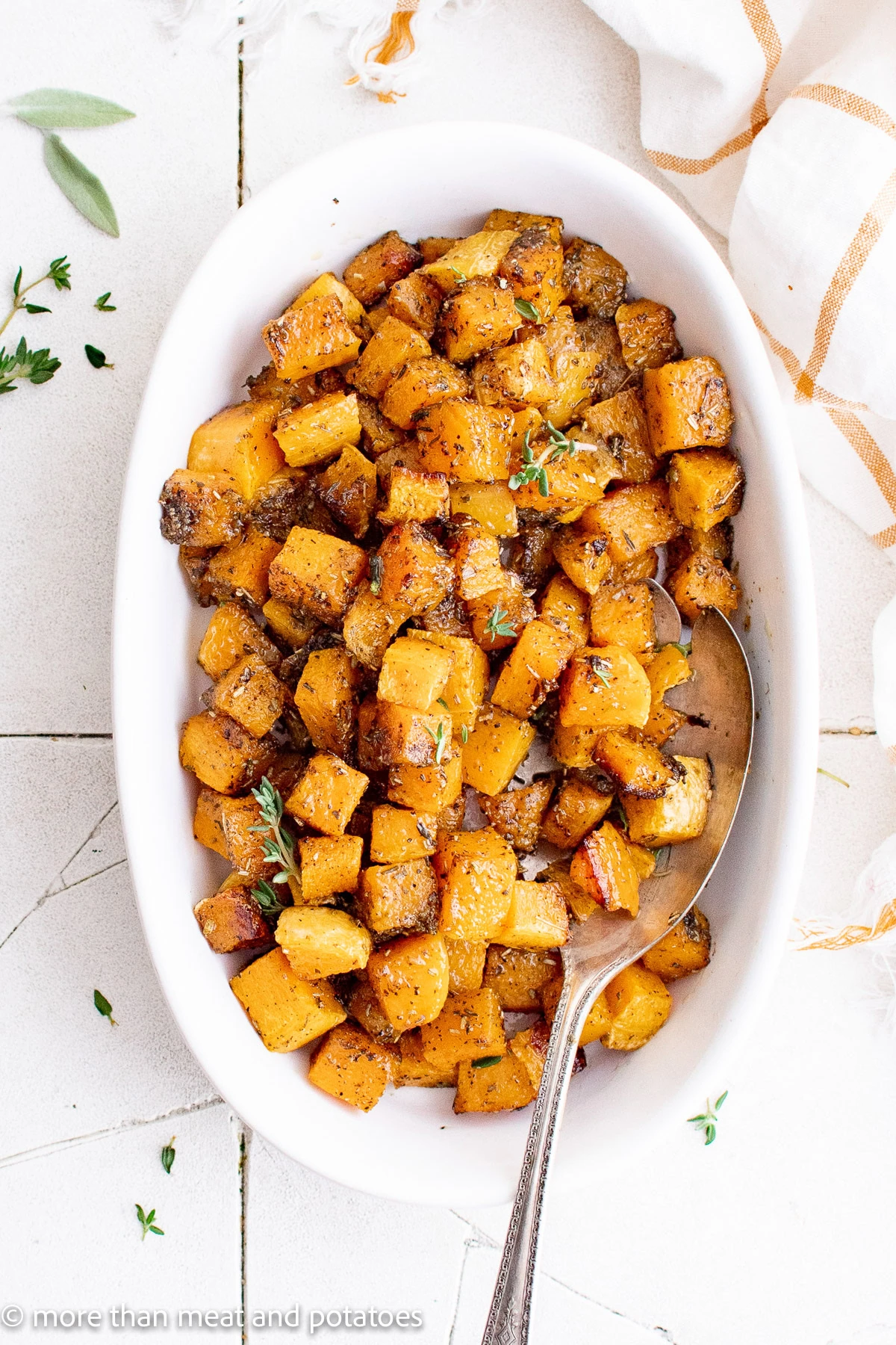 Overhead view of a dish filled with roasted butternut squash.