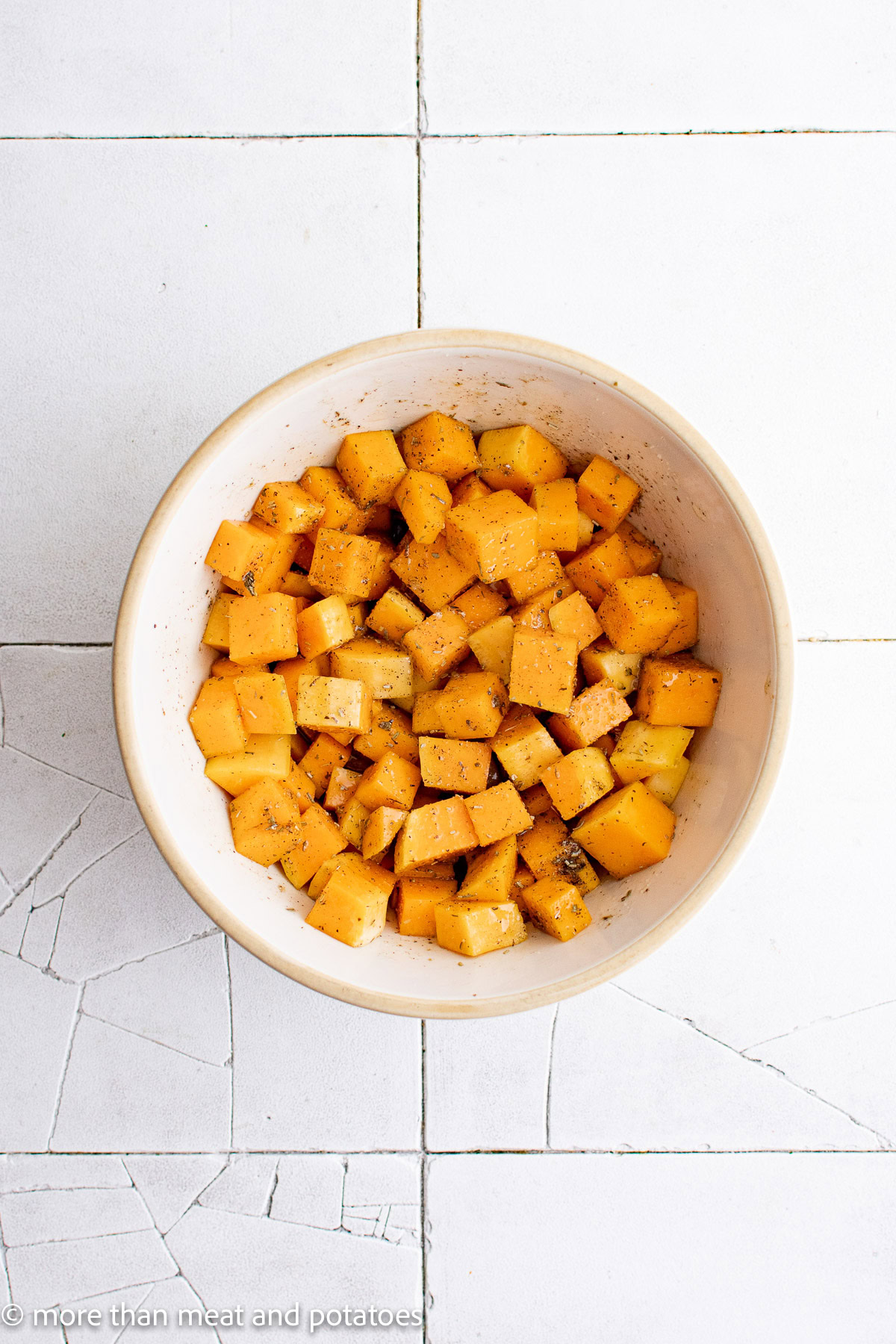 Cubed butternut squash tossed in seasonings and oil.