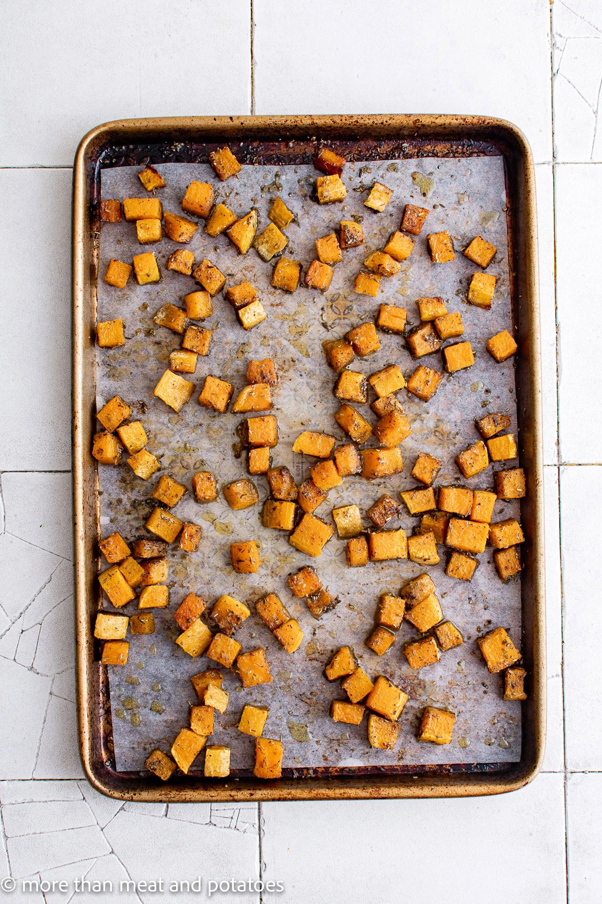 Roasted butternut squash on a sheet pan.
