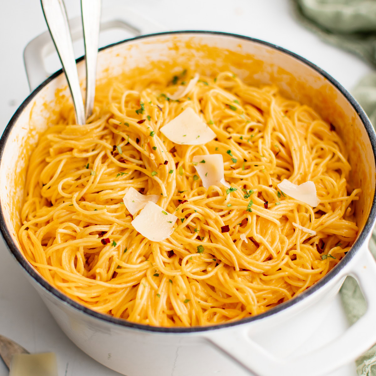 Creamy roasted red pepper pasta topped with Parmesan and parsley