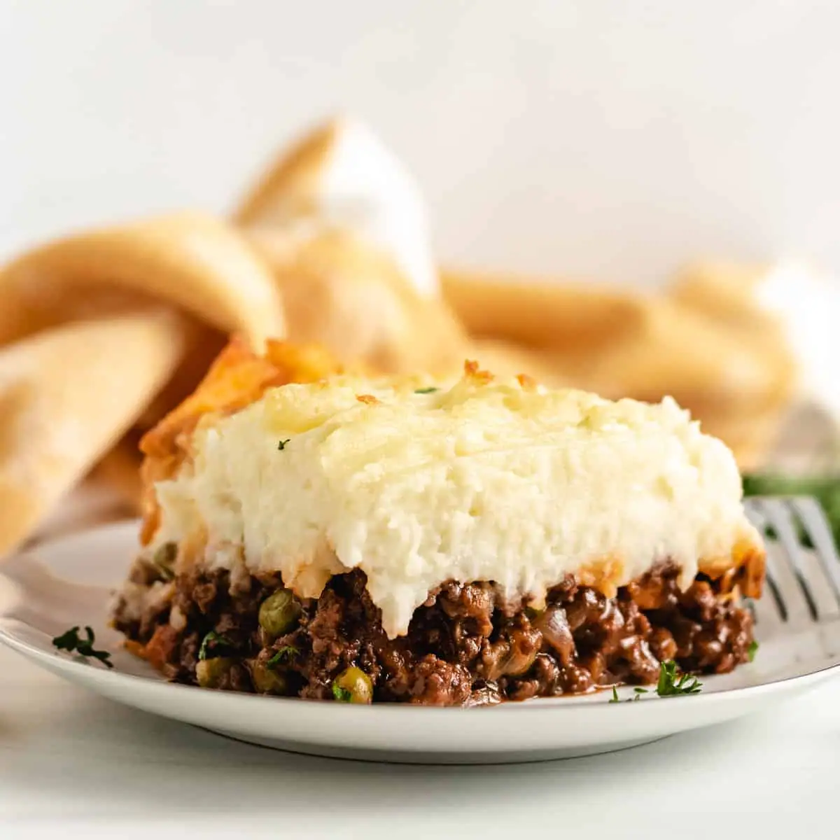 Slice of shepherd's pie with cheesy mashed potatoes.